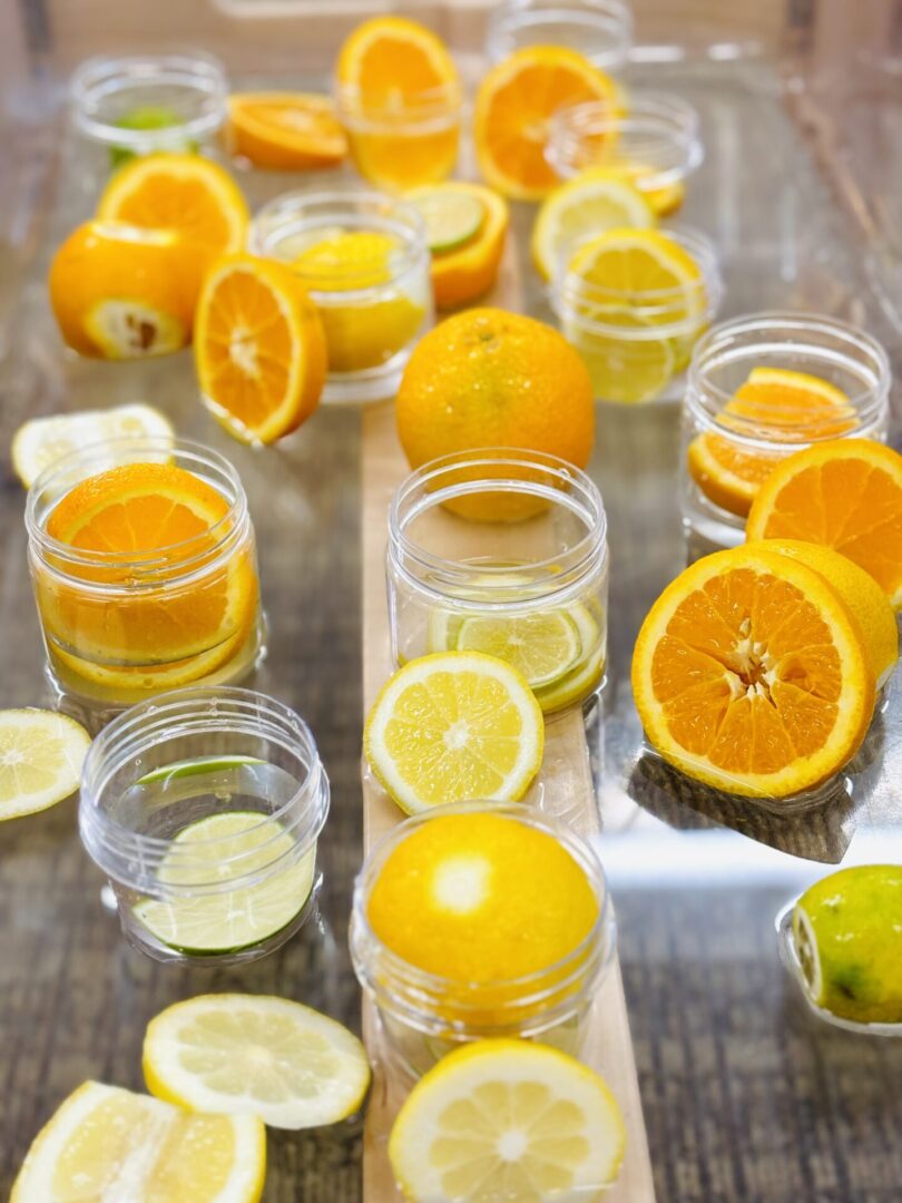 A table with oranges and lemons on it