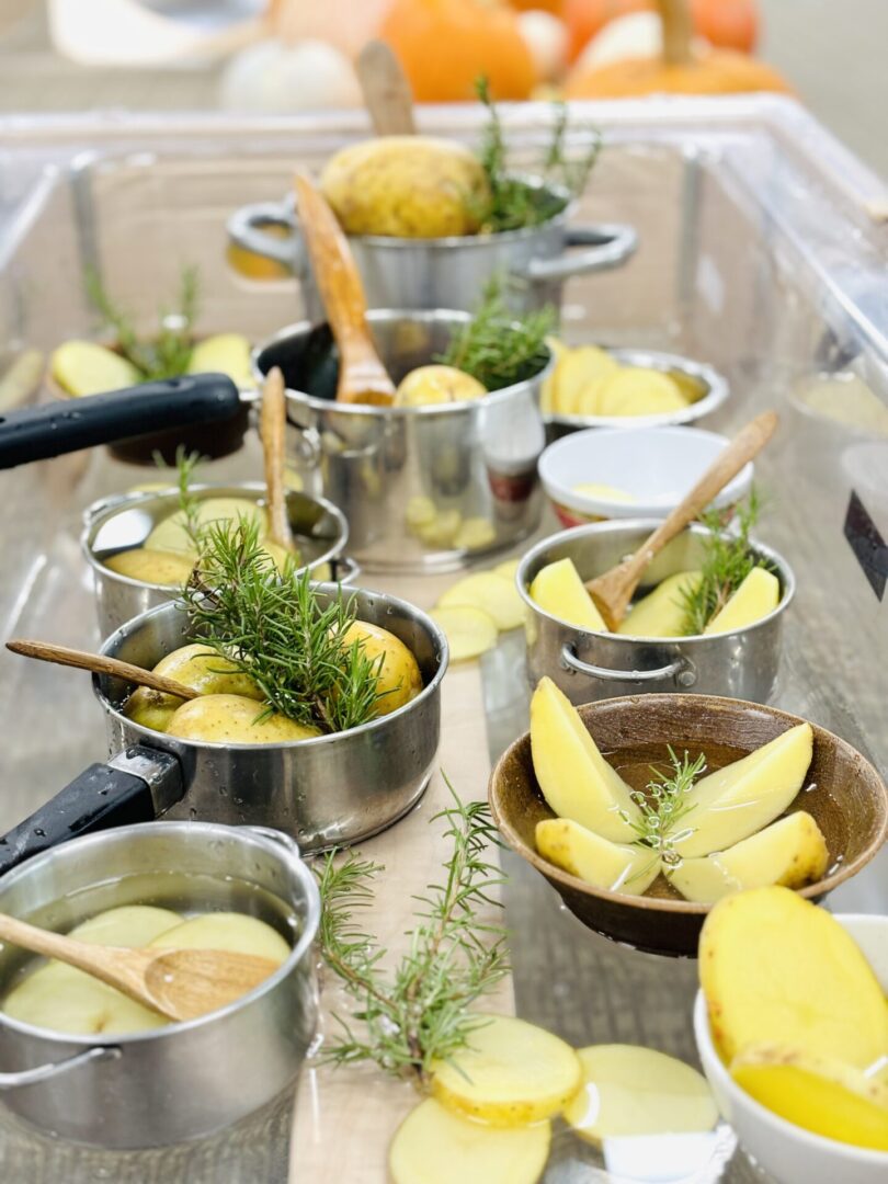 A table with many pots and bowls of food.