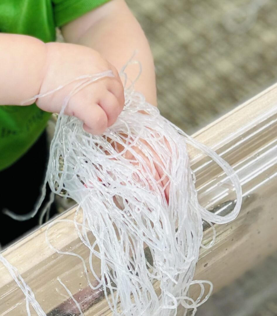 A child holding onto some string in their hand