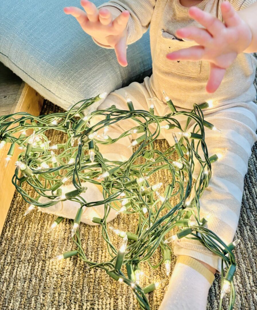 A child playing with lights on the floor